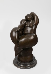 ARTIST UNKNOWN, cast bronze statue of a buxom female nude, mounted on turned stone base, 20th century, ​​​​​​​31.5cm high