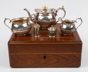 An antique English silver plated three piece tea service with ivory finial, attractively housed in a walnut and string inlay case with purple silk and velvet plush lining, 19th century; together with silver plated mustard pot and salt shaker, (3 items), the case 33cm wide