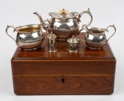 An antique English silver plated three piece tea service with ivory finial, attractively housed in a walnut and string inlay case with purple silk and velvet plush lining, 19th century; together with silver plated mustard pot and salt shaker, (3 items), t