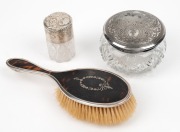 A sterling silver topped crystal vanity jar by Henry&nbsp;Matthews&nbsp;of Birmingham, circa 1903; a sterling silver and tortoise shell hand mirror by Edward&nbsp;Souter&nbsp;Barnsley of Birmingham, circa 1920; and an antique American silver plated lidded crystal jar, engrav