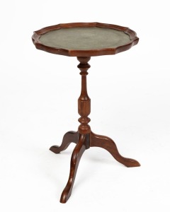 A vintage mahogany side table, the top with scalloped edge and leather insert on turned column and three cabriole legs, 20th century, 50cm high, 33cm wide, 33cm deep