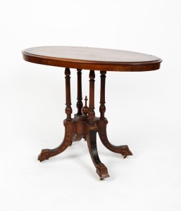 An antique English walnut oval top occasional table veneered in figured walnut with ebony crossbanded edge supported by a quad column base with carved and shaped legs, circa 1890, ​​​​​​​73cm high, 89cm wide, 53cm deep