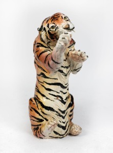 A vintage cast terracotta sculpture of a seated rampant tiger with enamel painted finish, 20th century, 92cm high