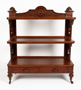 An antique English mahogany three tier dumbwaiter with shaped and carved back, two drawers to the base, standing on turned and carved legs with brass and porcelain&nbsp;castors, circa 1870, with original purchase receipt from Kittelty's Auction Rooms​​​​​​​, 1