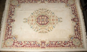 A pure wool carved floral rug on cream ground with burgundy highlights, 4m x 2.5m