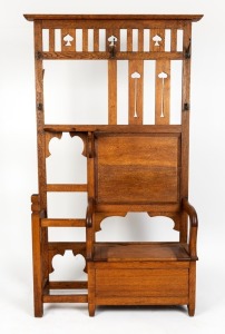 An antique oak hallstand with storage box base in the Arts & Crafts style, early 20th century. Note: Hooks damaged, mirror requiring installation, 201cm high, 110cm wide, 30cm deep