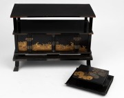 An antique Japanese black lacquered two door cabinet, together with a crescent form box and tray, Meiji Period, (3 items), the cabinet 26cm high, 35cm wide, 17cm deep