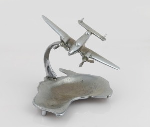 Trench Art: Lockheed Hudson mounted on ashtray, c. 1940s, solid chrome-plated brass, 13cm high and 14.5cm wingtip to wingtip.&nbsp;