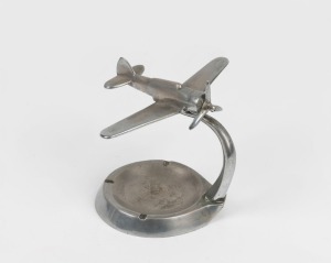 Trench Art: CAC Wirraway&nbsp;mounted on ashtray, c. 1940s, solid chrome-plated brass, 11cm high and 14cm wingtip to wingtip.