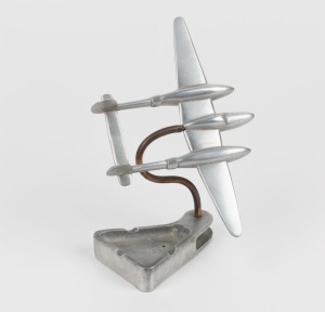 Trench Art: Lockheed P-38 Lightning, mounted on ashtray,&nbsp;aluminium, c. 1940s, 17cm high and 20.5cm wingtip to wingtip.