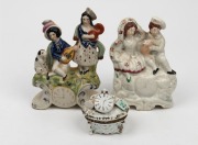 STAFFORDSHIRE&nbsp;antique English pottery figural groups with clock displays, together with an antique Continental porcelain trinket box with pocket watch top, 19th century, (3 items), the largest 19cm high