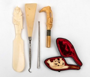 An antique carved Meerschaum pipe in case, a sterling silver pen stylus, carved marine ivory parasol handle, and two carved ivory shoehorns, 19th/20th century, (5 items), ​​​​​​​the largest 23cm long&nbsp;
