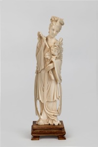 A Chinese carved ivory statue of a lady holding a peony, on later timber stand, early to mid 20th century, 23cm high overall