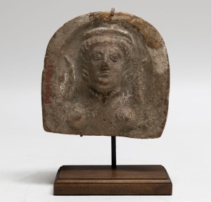 A Roman terracotta antefix&nbsp;on later bespoke wooden stand, 1st century, A.D., 16cm high PROVENANCE: Purchased from Fragments of Time Auction, November 6th, 2003 - Lot 50. Formerly in the Charterhouse Collection, United Kingdom. Copy of the auction catalog