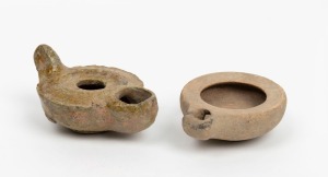 A Roman pottery oil lamp; together with a Hellenistic terracotta oil lamp, (2 items), the larger 9cm