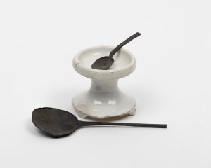 An antique Dutch ceramic salt cellar; together with two antique Dutch pewter spoons, 18th century, the cellar 18cm high