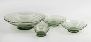 WHITEFRIARS&nbsp;four English sea green glass footed bowls with ribbon trail decoration, mid 20th century, the largest 31cm diameter