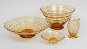 WHITEFRIARS&nbsp;English golden amber glass group comprising of three footed bowls and a footed vase, all&nbsp;with ribbon trail decoration, designed by Barnaby Powell,&nbsp;mid 20th century, (4 items), the vase with original blue foil export label, the largest bowl 31c