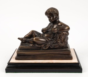 A cast bronze statue of a reclining putti figure on timber and marble base, 20th century, 26cm high