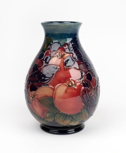 MOORCROFT&nbsp;"Finch and Berry" pottery vase on blue ground, stamped "Moorcroft, Made In England, W.M.", 19cm high