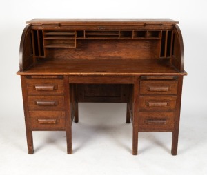 An antique Australian ash desk with six drawers,&nbsp;tambour front and fitted interior, early 20th century, stamped "F. K. Cox & Co. Pty. Ltd. Kensington. European Labour Only", 113cm high, 138cm wide, 75cm deep