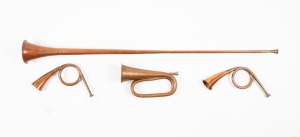 Vintage copper and brass bugle, Heraldic horn and two hunting horns, 19th and 20th century, the largest 125cm long