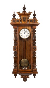 An antique German made Vienna regulator wall clock in walnut case with split column decoration, two train eight day weight driven movement with Roman numerals and subsidiary seconds dial, 19th century, 134cm high