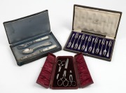 A boxed sterling silver cutlery setting for one, comprising of a fork, spoon and knife with attractively carved mother of pearl handles; together with a boxed set of twelve antique English silver plated cake forks and a boxed set of three scissors, 19th/2