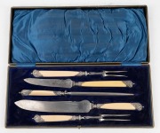 An antique English five piece carving set in original plush fitted box with&nbsp;ivorine handles with silver plated mounts, 19th century, the box 43.5cm wide