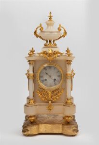 A fine quality antique French mantle clock in alabaster case with turned columns and gilt ormolu mounts resting on original shaped carved and gilt timber base, eight day time and strike movement with Roman numerals, 19th century, 51cm high overall