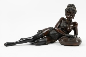 A cast bronze statue of a scantily clad lady, 20th century, ​​​​​​​29cm high, 52cm long