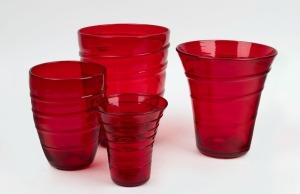 WHITEFRIARS group of four English ruby red glass vases with ribbon trail decoration designed by Barnaby Powell, mid 20th century, the largest 23cm high