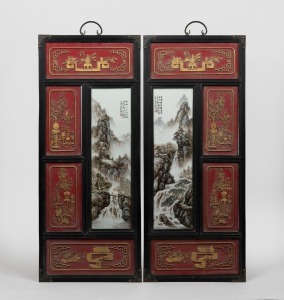A pair of Chinese porcelain panels with landscape scenes, housed in carved timber frames with red and gilt highlights, Republic period, 20th century, ​​​​​​​95 x 40cm each overall