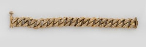 An antique South American silver bracelet with engraved decoration and remains of gilt finish, 16cm long, 27 grams