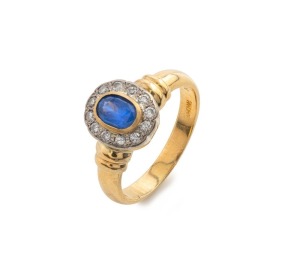 An 18ct yellow gold ring adorned with blue sapphire surrounded by brilliant cut white diamonds, stamped "18ct", 9.6 grams total
