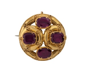 An antique Australian 18ct gold circular brooch, set with four purple stone, 19th century, ​​​​​​​3.2cm wide, 9.2 grams total