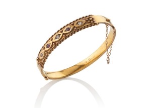 An antique Australian 18ct yellow gold bangle, set with three diamonds and two rubies, Melbourne origin, 19th century, marks only partially legible, 11.7 grams