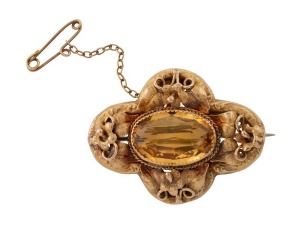 An antique Australian 18ct yellow gold brooch with leaf decoration and large cut citrine, 19th century, marks obscured by safety chain, 4cm wide, 7.6 grams