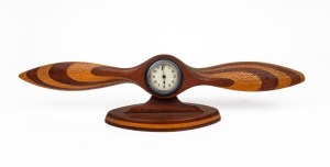 Eight-day mantle clock mounted in wooden propeller, early 20th century, 12.5 cm high, 52.5cm wide.