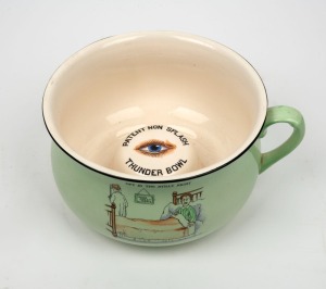 CROWN DEVON "PATENT NON SPLASH THUNDER BOWL" antique English porcelain chamber pot with clockwork musical mechanism, together with a copy of the book "TEMPLES OF CONVENIENCE" by Lucinda Lambton, where the same model is feature on the back cover, early 20th century, 13.5cm high, 27cm wide