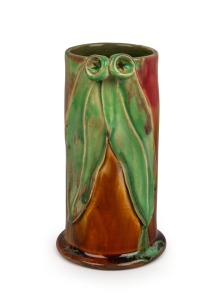 REMUED pink and brown glazed cylindrical pottery vase with lime green highlights, with applied gumnuts and leaves, incised "Remued", 17cm high