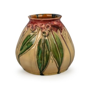 REMUED pottery vase with rare experimental glaze highlighted in pink and green with brown and blue accents, decorated with three gum nuts, three leaves and branch handle, incised "Remued Hand Made, 154M", 16cm high, 18cm wide