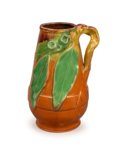 PAMELA rare pottery vase with experimental orange and yellow glaze with green and pink highlights, decorated with applied gumnuts, leaves and branch handle, incised " Pamela Hand Made", 22cm high 