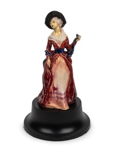 MARGUERITE MAHOOD pottery statue of a lady in a red dress, with bespoke later timber stand,  incised "Marguerite Mahood", 25.5cm high (not including stand)