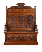 Circle of ROBERT PRENZEL&nbsp;Australian blackwood hall seat with carved griffin and face mask decoration, early 20th century, 138cm high x 115cm wide x 41cm deep