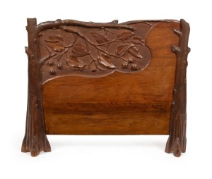 An Australian Arts & Crafts blackwood firescreen carved with gumnuts and leaves with branch decoration, in the manner of Prenzel, early 20th century, 70cm high, 86cm wide, 17cm deep