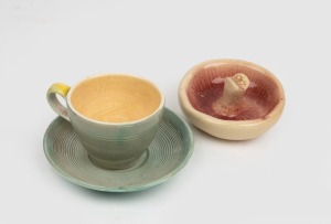 ARTHUR MERRIC BOYD green glazed pottery cup and saucer together with a pottery mushroom ornament, (3 items), signed "A.M.B.", the saucer 12.5cm diameter