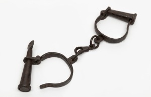 Replica convict handcuffs with key, 20th century, 29cm wide