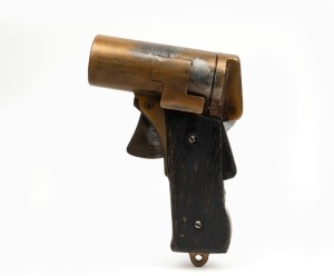 An American military flare gun, stamped "PISTOL, PYROTECHNIC-M2 No.5631 INSP. F.A.M. U.S. PROPERTY", note replaced wooden grips,