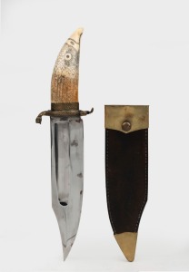 An Australian hand-crafted Bowie knife with scrimshawed whale's tooth handle and leather scabbard, 20th century, blade stamped "K. B. S., Castlemaine, Aust.", 36cm long